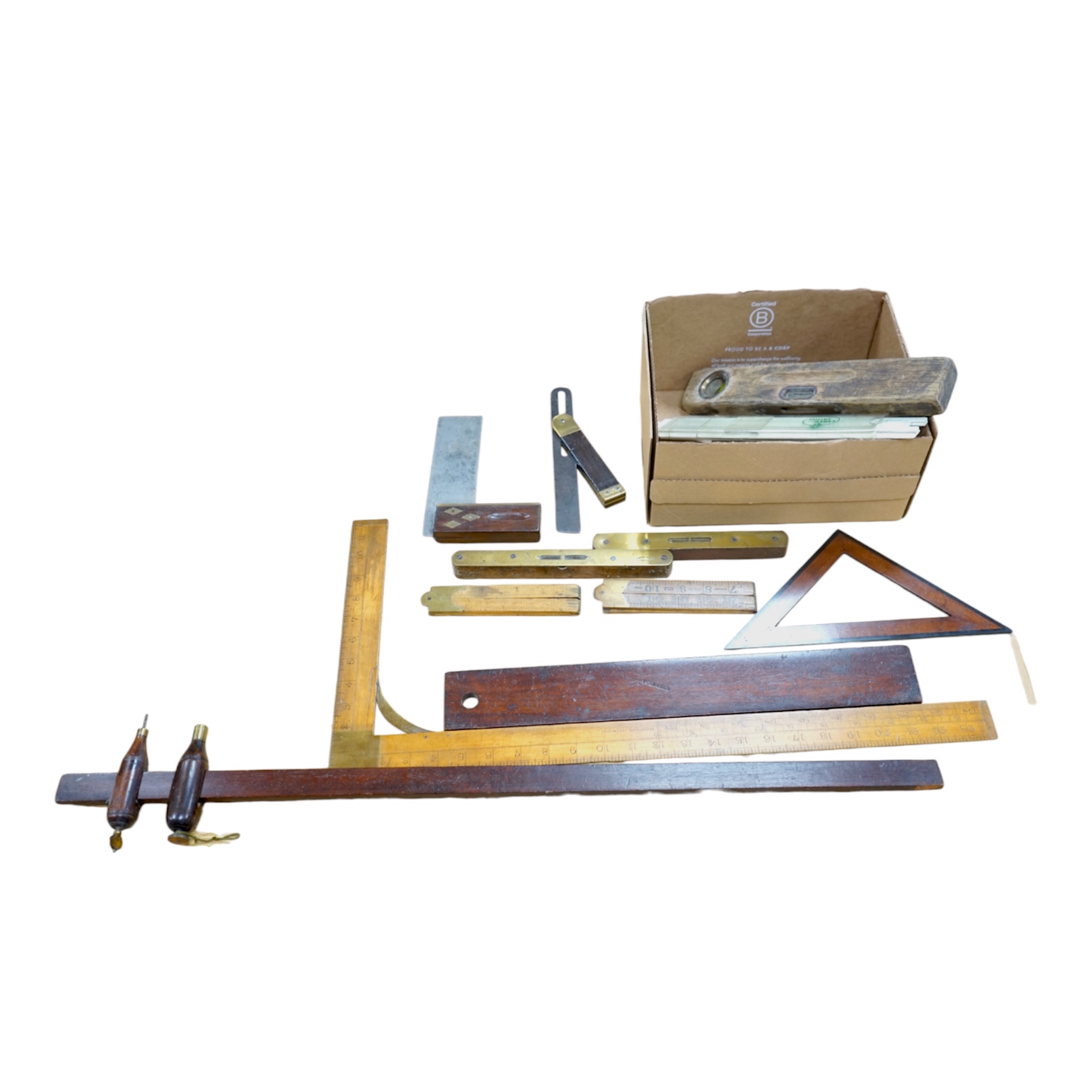 A collection of 19th and 20th century drawing instruments, including; levels, rulers, a set square etc. longest 79cm. Condition - variable, mostly fair to good